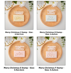Detail view of transparent acrylic Merry Christmas cookie stamps on colorful fondant icing