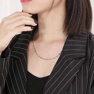 Minimalist silver beaded stainless steel choker necklace styled on a female model