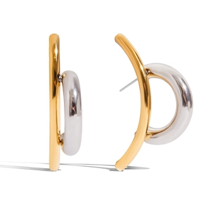 Detailed macro view of stylish two-tone gold and silver circular hoop earrings
