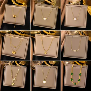 Collection of nine gold-plated titanium steel necklaces with pearls and geometric pendants