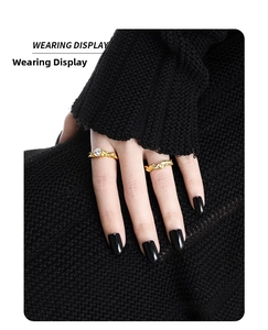 Wearing display of two gold twisted rope rings with a sparkling round zircon stone