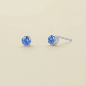 Minimalist silver-tone stainless steel stud earrings featuring round blue sapphire rhinestones