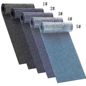 Close-up of five rectangular denim patches in shades of blue and black for DIY clothing