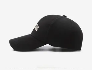 Side view of black cotton baseball cap showing detailed embroidery and long visor edge