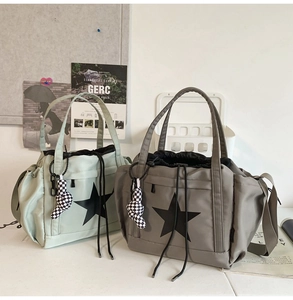 Detail of water-resistant nylon tote bags with star print and drawstring closure