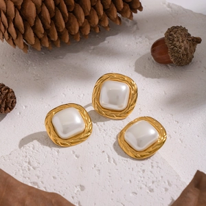 Vintage gold square stud earrings with white pearl and twisted metal border on stone