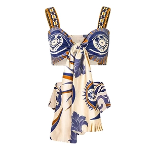 Close-up of ethnic print bikini top featuring ruffle straps and large central tie knot