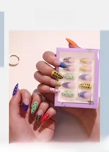 Detail of French colorful polka dot press-on nails with almond shape and packaging