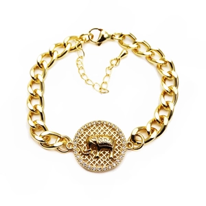 Detail view of a gold-plated circular pendant with an elephant and micro-pave CZ stones