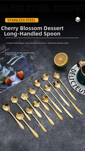 Close-up of golden stainless steel dessert spoons with diverse creative flower head designs