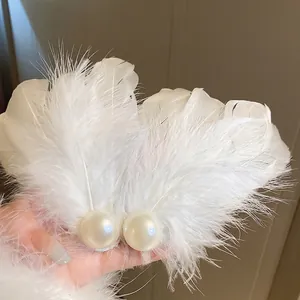 Elegant white feather hair clips with large cream pearls in a set for women's hairstyle