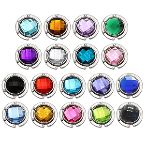 Array of 13 colorful acrylic gem bag hooks for desk, showing various faceted crystal styles