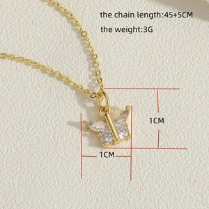 Detailed view of golden butterfly pendant with clear cubic zirconia stones and dimensions