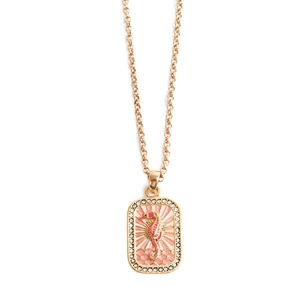 Detailed close-up of golden seahorse pendant with pink enamel and sparkling zirconias