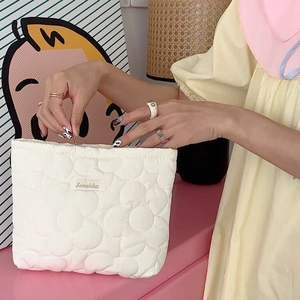 Large capacity white floral quilted makeup bag with soft texture and logo detail
