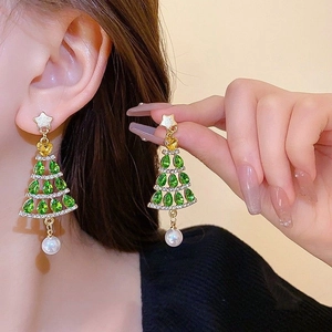 Close-up of green crystal Christmas tree earring with gold star and white pearl drop