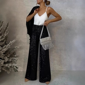 Women's chic sequin wide-leg pants with black suit jacket and silver tassel handbag