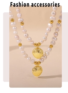 Macro detail of double-layered necklace with irregular freshwater pearls and gold pendants