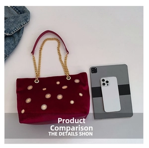 Burgundy velvet tote bag with gold sunburst rivets shown next to a tablet for size comparison