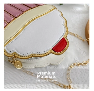 Detailed close-up of cupcake shaped crossbody bag with pink leather and gold chain strap