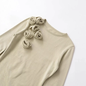 Elegant beige long-sleeve knit sweater featuring 3D rose flower decorations on a white background
