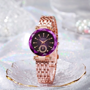 Detail of rose gold ladies watch featuring a purple faceted dial and crystal indices
