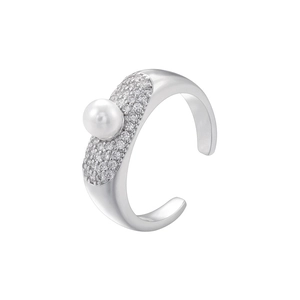 Detailed close-up of a silver ring with a central pearl and micro-pave crystals