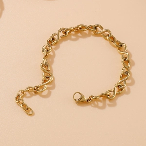 Elegant gold infinity symbol chain bracelet with lobster clasp on beige background
