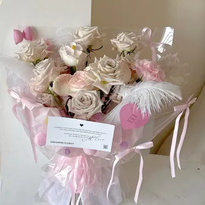 Artistic bouquet with champagne roses, pink carnations and white ostrich feathers