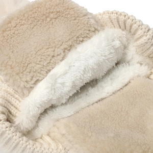 Cozy winter knit hat for kids with thick white fleece lining and soft beige wool exterior
