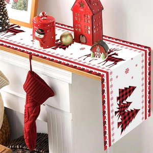 Christmas table runner with red buffalo plaid reindeer and snowflake motifs on fireplace