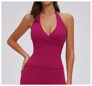 Close-up of deep V-neck halter yoga vest with pleated details in bright magenta
