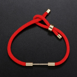 Close-up of adjustable red woven cord bracelet with gold metal accents and sliding knot