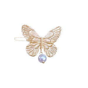 Elegant gold butterfly hair clip with light purple pearl bead in center on white background