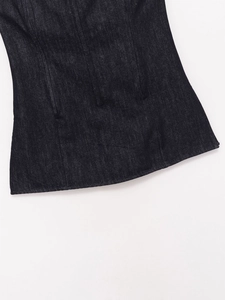 Detailansicht des Saums eines dunkelblauen Jeans-Oberteils mit präzisen Nähten und Textur