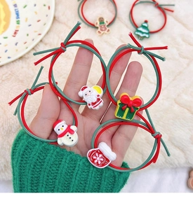 Close-up of festive Christmas hair scrunchies set featuring Santa and reindeer charms