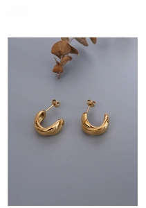 Detail view of gold-plated stainless steel chunky C-shape hoop earrings with a polished finish