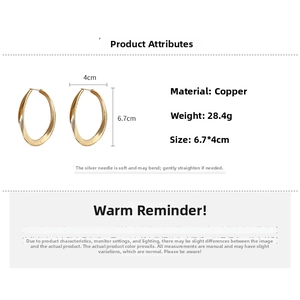 Detailed view of large golden twisted oval hoop earrings with 6.7cm by 4cm dimensions