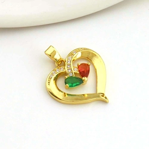 Macro shot of gold heart pendant with red and green pear-cut stones and white zircon