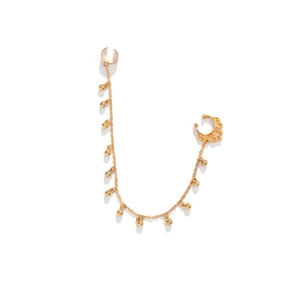 Detail of gold nose ring chain with spherical pendants and ear cuff on white background