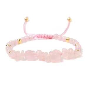 Detailed close-up of rose quartz beaded bracelet with gold accents and pink braided cord