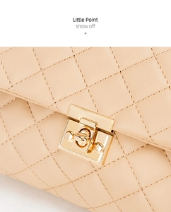 Macro detail of beige quilted PU leather shoulder bag with golden metallic twist lock