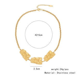 Detail view of irregular molten texture gold pendants on a stainless steel chain