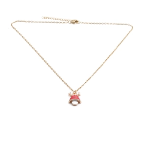 Detail of gold necklace with red bell pendant, golden antlers and white pearl drop