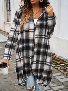 Detail of checkered zip-up hoodie featuring color-block pattern and metal zipper closure