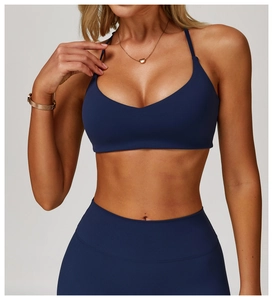 Close-up of navy blue halter sports bra and high-waisted leggings in brushed matte fabric