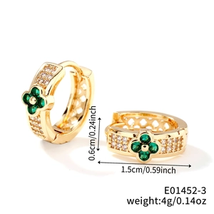 Detail view of gold clover earrings with green zircon and white crystals showing size 1.5cm