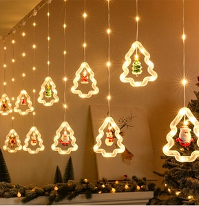 Detail of warm white Christmas light strings featuring hanging reindeer and Santa figurines