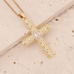 Macro shot of a gold-plated 18K cross pendant with micro-paved sparkling zircon stones