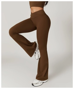Detail of high waisted crossover V-waist flared yoga pants in dark brown quick dry fabric
